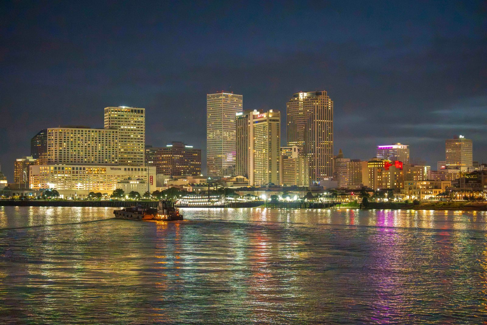 The New Orleans skyline lit at night across the Mississippi, where Viking US river cruises 2027 voyages begin